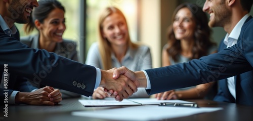 A successful business meeting with a handshake, symbolizing partnership and collaboration among diverse professionals. Perfect for corporate and business-related themes.