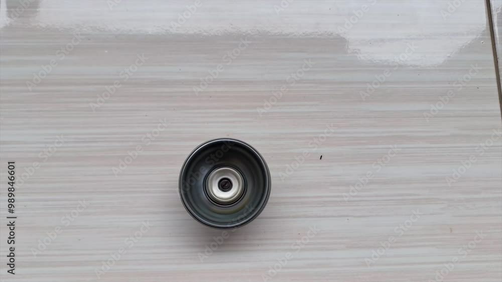 A Spinning Top Toy Made Of Tin Cans Rotates Quickly On A White Floor A Spinning Top Toy Made Of Tin Cans Rotates Quickly On A White Floor