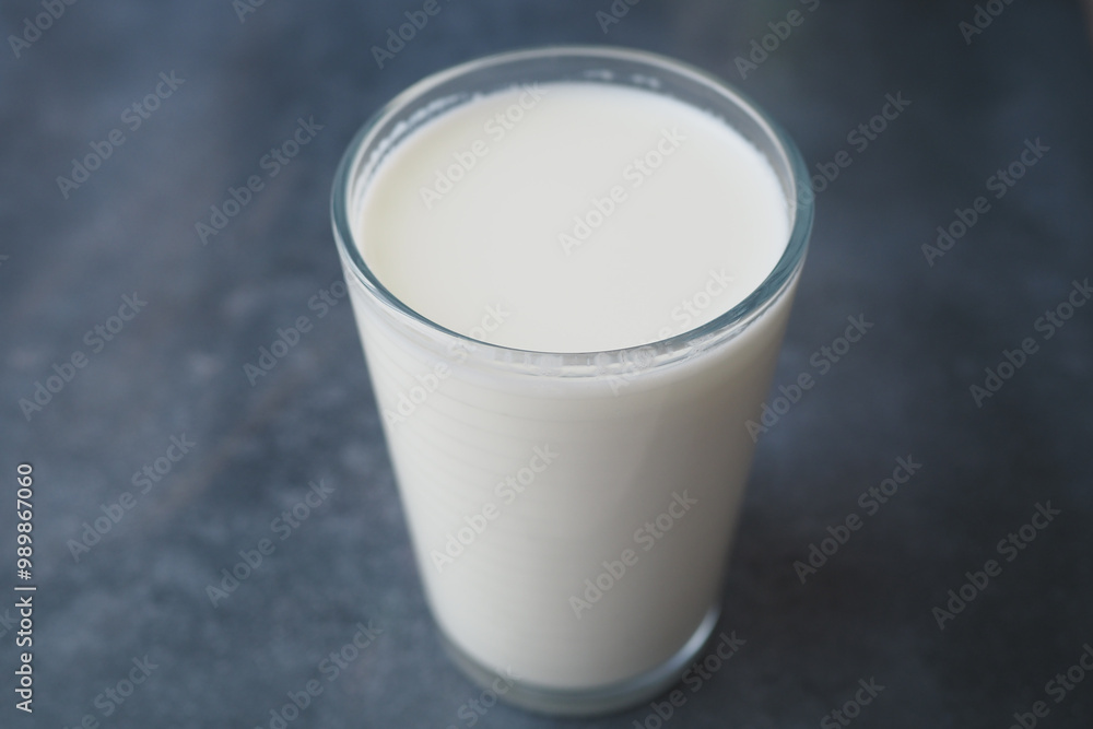 A Fresh Glass of Milk Presented on a Dark Background, Highlighting its Creamy Texture and Taste A Fresh Glass of Milk Presented on a Dark Background, Highlighting its Creamy Texture and Taste
