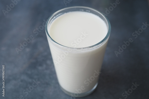 A Fresh Glass of Milk Presented on a Dark Background, Highlighting its Creamy Texture and Taste