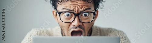 A business owner submitting a grant application online with a look of determination photo