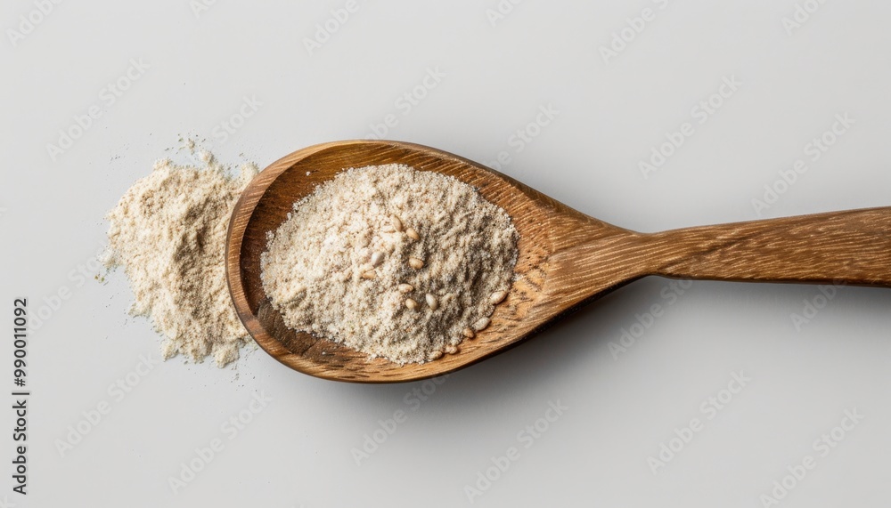 Natural flour in a wooden spoon on a gray background with a sprinkle on the side showcasing the texture and quality of the product Natural flour in a wooden spoon on a gray background with a sprinkle on the side showcasing the texture and quality of the product
