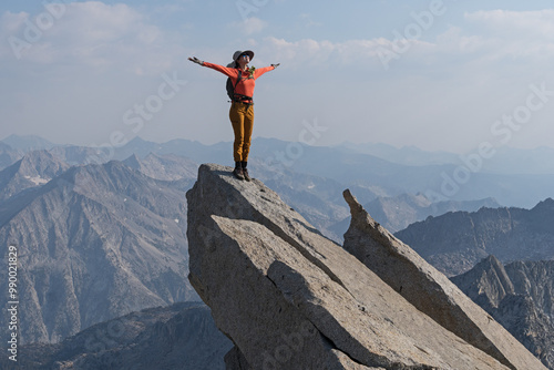 Woman Celebrating On Mountain Top On Columbine Peak In The Sierra Nevada Mountains Of California