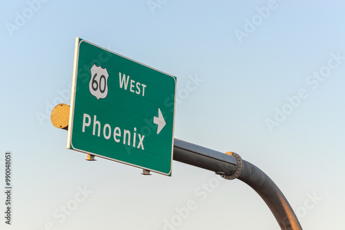 A green highway guide sign featuring a right arrow directs motorists to westbound U.S. Route 60 toward Phoenix, Arizona photo