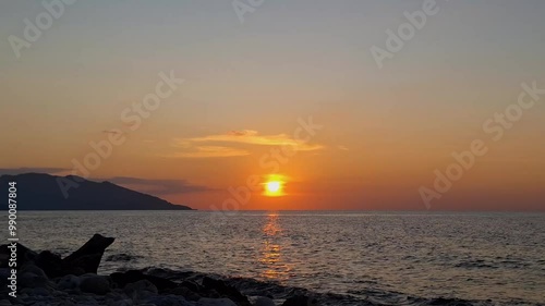 view of the sky and sun at sunset on the beach