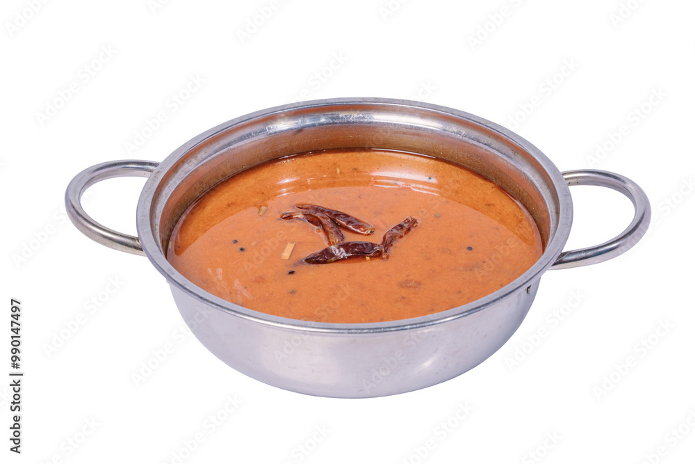 A small, round metal bowl filled with a thick, reddish-orange curry with dried red chili peppers floating on top. A small, round metal bowl filled with a thick, reddish-orange curry with dried red chili peppers floating on top.
