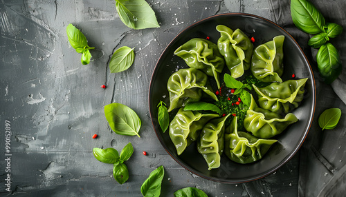 Delicious green dumplings (gyozas) served on grey wooden table, flat lay photo