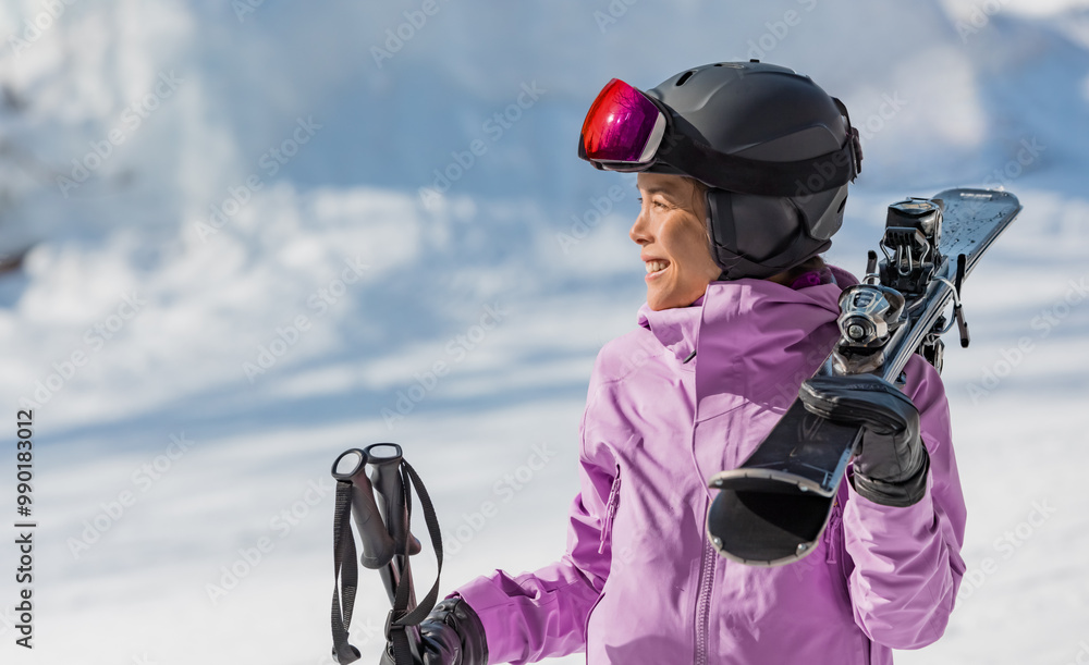Naklejka premium Skiing woman portrait. Skier woman athlete going skiing on slope ski piste wearing helmet and ski goggles in winter nature landscape. Winter sports active lifestyle