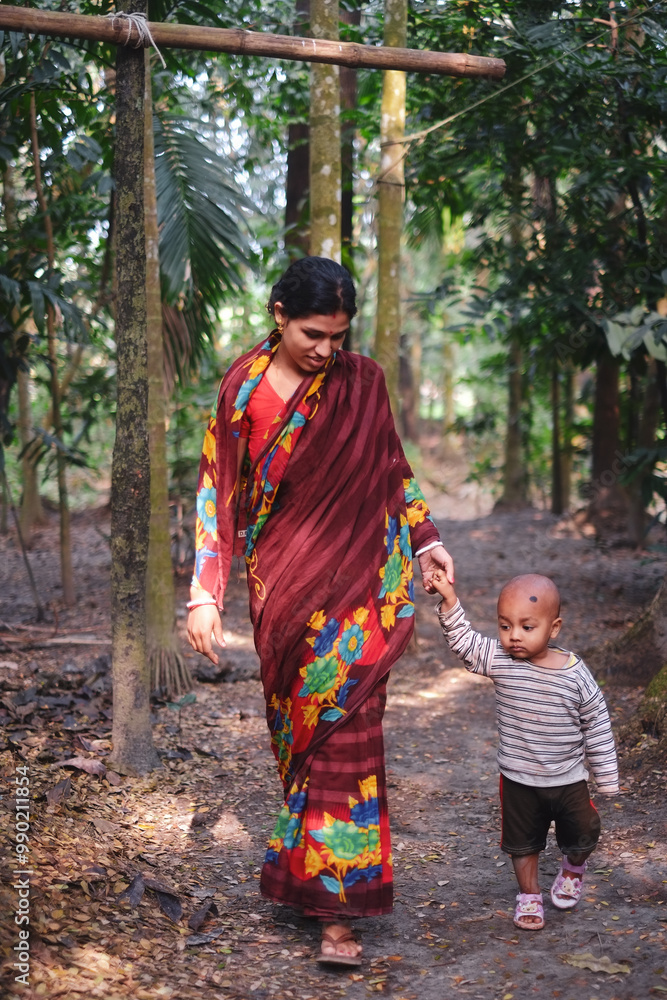 Young rural mother walking in a forest with her baby boy Young rural mother walking in a forest with her baby boy