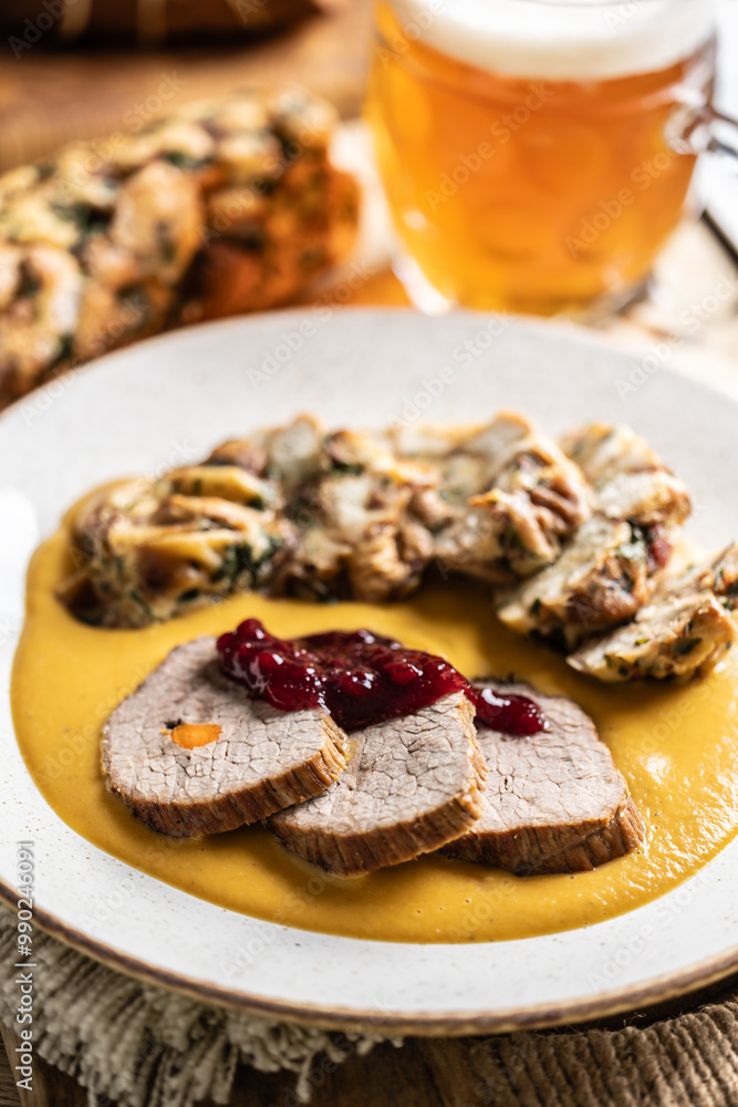 Beef fillets from sirloin steak with traditional Czech sauce, Karlovy Vary dumpling with cranberries and good Czech beer Beef fillets from sirloin steak with traditional Czech sauce, Karlovy Vary dumpling with cranberries and good Czech beer