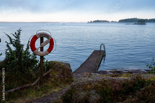 Lifebuoy and bathing jetty in Vastanvik Motala Sweden photo