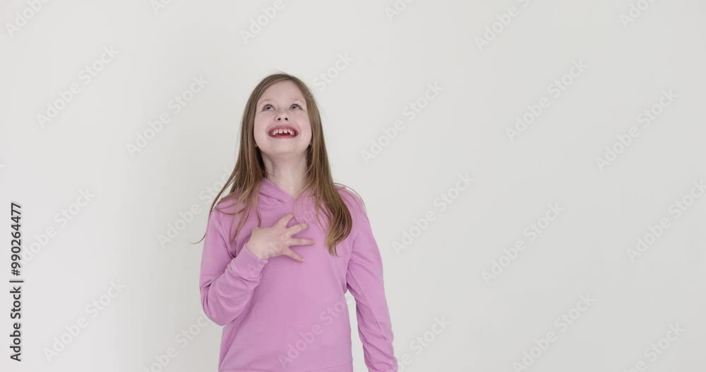 Blonde girl laughs joyfully pointing forward on white background. Excited preteen child shows clearly vibrant emotions and happiness feeling Blonde girl laughs joyfully pointing forward on white background. Excited preteen child shows clearly vibrant emotions and happiness feeling