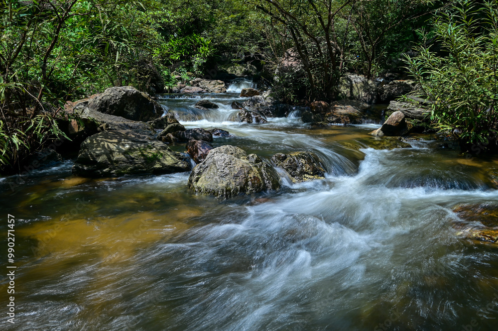 A small waterfall created from water flowing from Khlong Lan Waterfall. In Namtok Khlong Lan National Park Kamphaeng Phet Province A small waterfall created from water flowing from Khlong Lan Waterfall. In Namtok Khlong Lan National Park Kamphaeng Phet Province