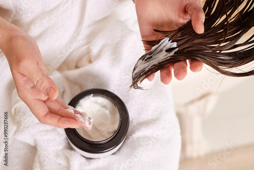 Applying hair mask to wet hair photo