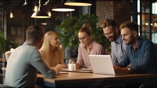 A team of business professionals interacts positively around a laptop in a modern office, reflecting a collaborative and innovative work environment.