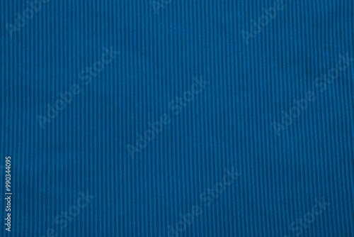 Smooth texture of deep blue fabric with vertical stripes displayed on a flat surface