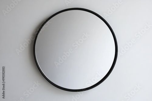 Modern round mirror with sleek black frame mounted on a plain wall
