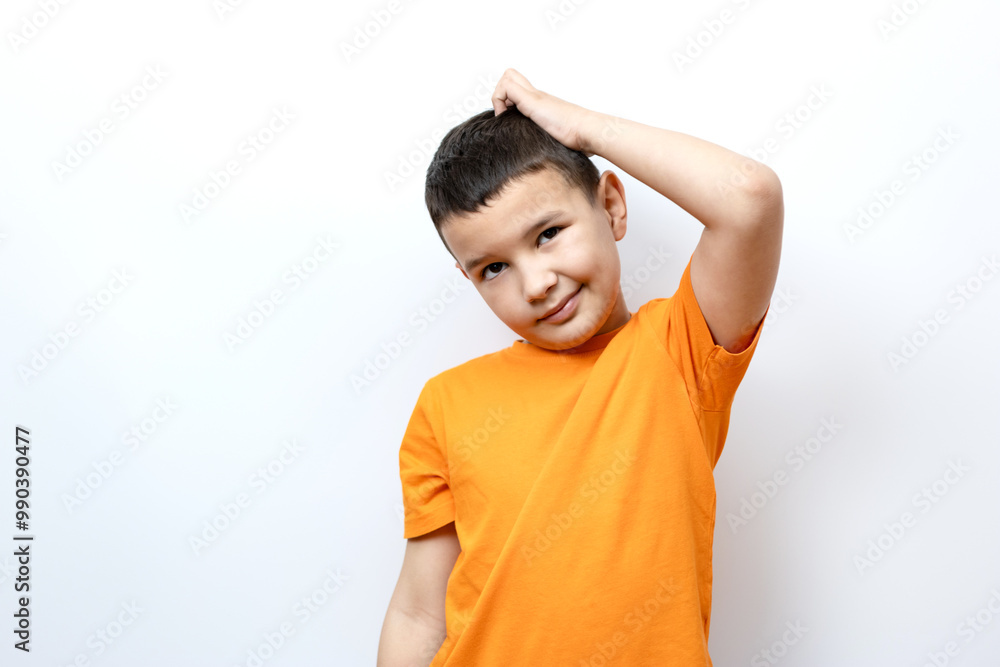 A guy in an orange T-shirt scratches the back of his head. A guy in an orange T-shirt scratches the back of his head.