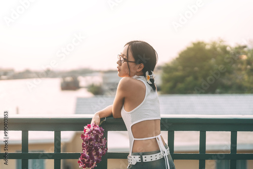 Canvas-taulu Portrait asian woman nostalgia trend fashion styles holding orchid flower at Ban