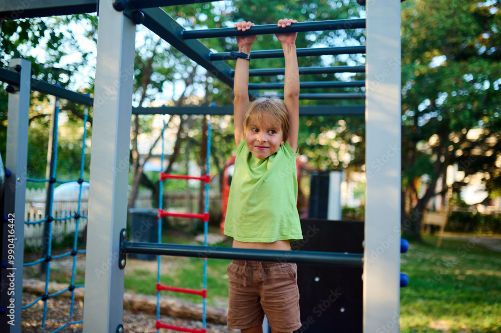 A child climbs confidently on playground equipment under a clear sky surrounded by greenery during a sunny afternoon A child climbs confidently on playground equipment under a clear sky surrounded by greenery during a sunny afternoon