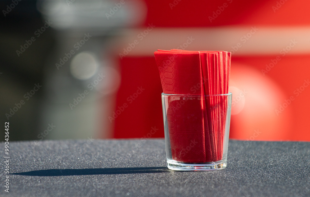 A glass with a napkin in it A glass with a napkin in it