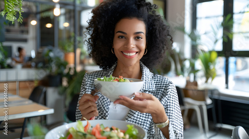 Young woman eating salad in an office