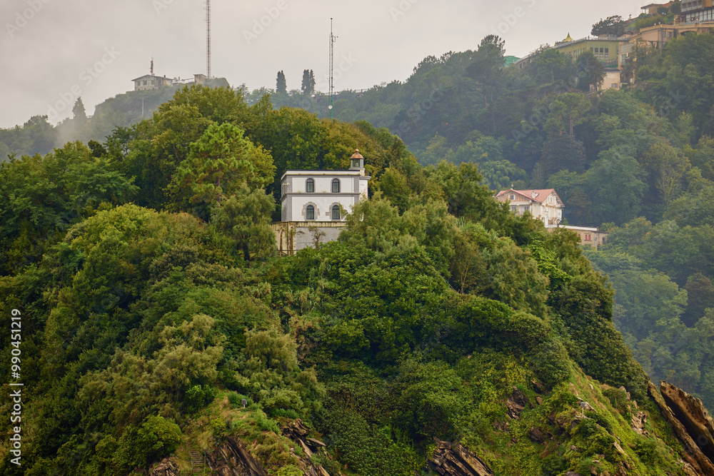 Obraz premium Saint Klara the lighthouse on the top of Santa Clara island in San Sebastian, Spain