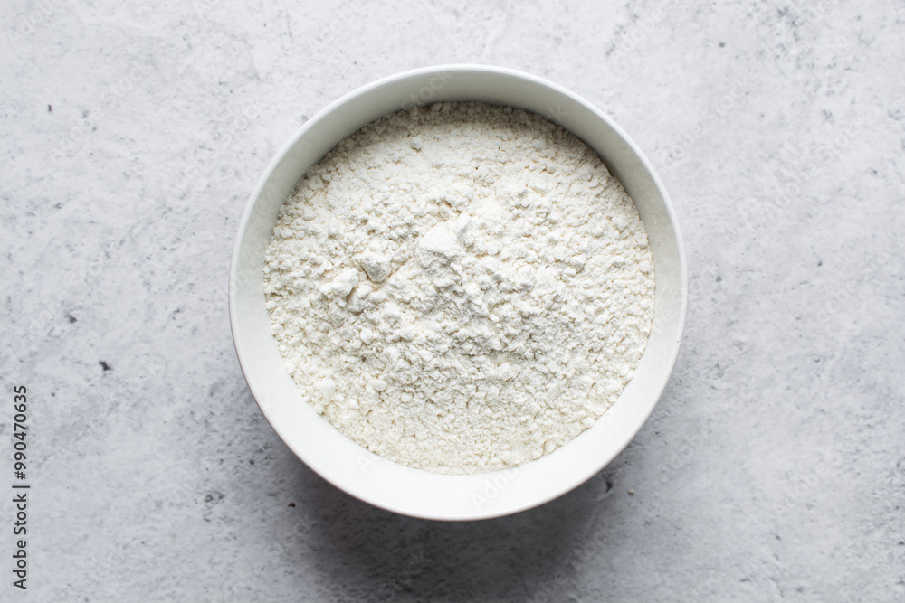 overhead view of All purpose flour in a bowl, top view of baking flour in a ceramic bowl overhead view of All purpose flour in a bowl, top view of baking flour in a ceramic bowl