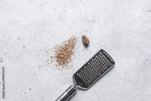 Overhead view of Nutmeg being grated on marble countertop photo