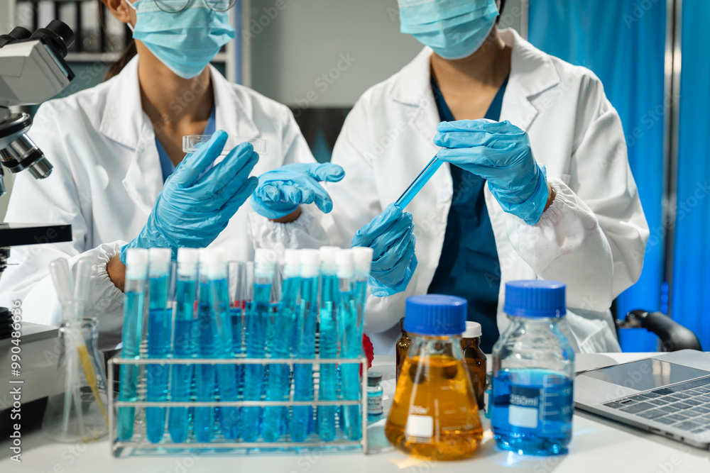 Chemist scientist holding test tube and tablet conducting experiment in laboratory with equipment, science concept. Chemist scientist holding test tube and tablet conducting experiment in laboratory with equipment, science concept.