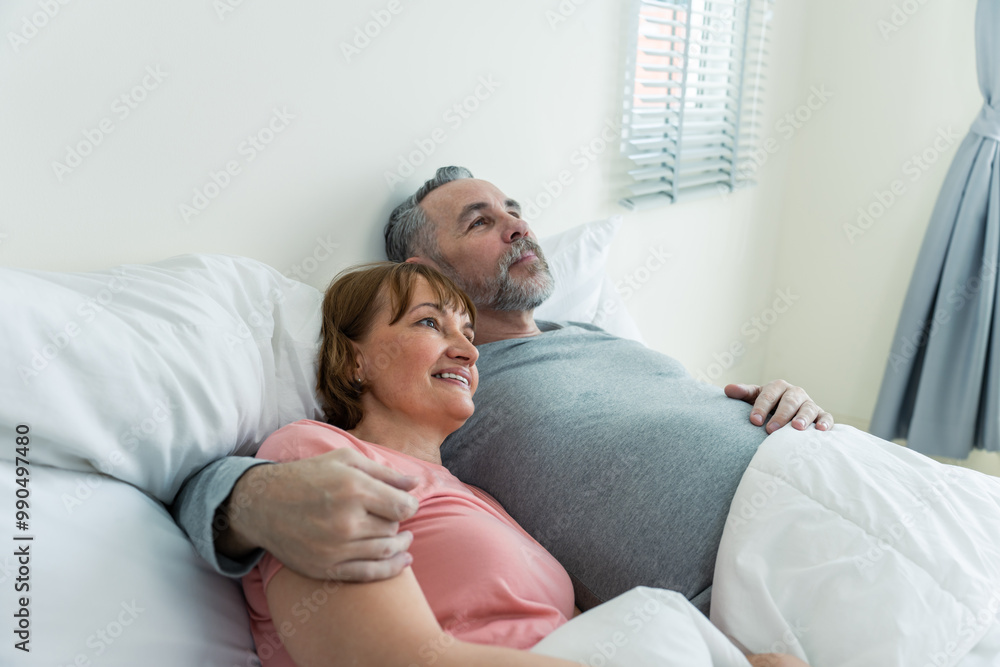 Caucasian senior older couple lying down on bed after wake up in house. Caucasian senior older couple lying down on bed after wake up in house.
