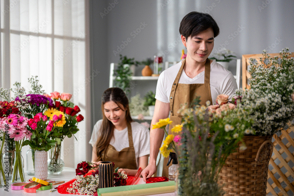 Asian young florist couple completing beautiful bouquet in flower shop. Asian young florist couple completing beautiful bouquet in flower shop.