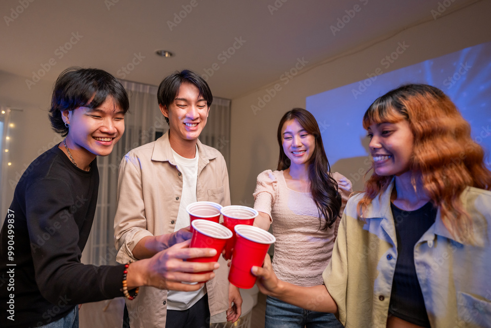 Fototapeta premium Group of Asian friends having evening party in living room at home. 
