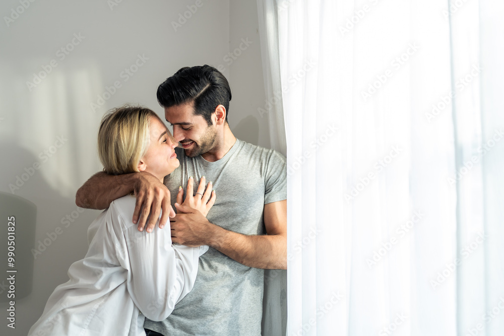 Caucasian young couple spend free time together in bedroom at home. Caucasian young couple spend free time together in bedroom at home.