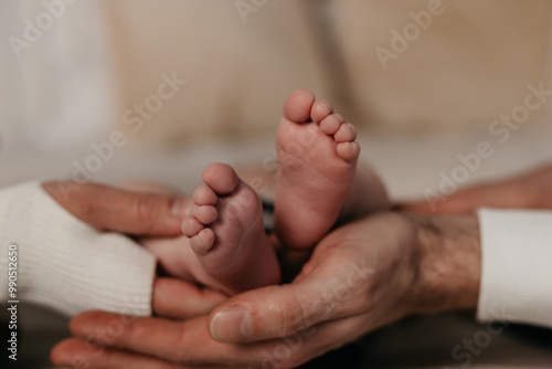 Children's legs in the hands of parents