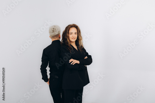 a dancing couple of social dance teachers in a black suit on a white background photo