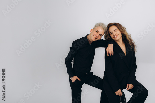 a dancing couple of social dance teachers in a black suit on a white background photo