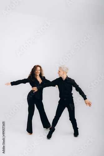 beauty couple dancing social danse kizomba or bachata or semba or taraxia , on light grey background photo