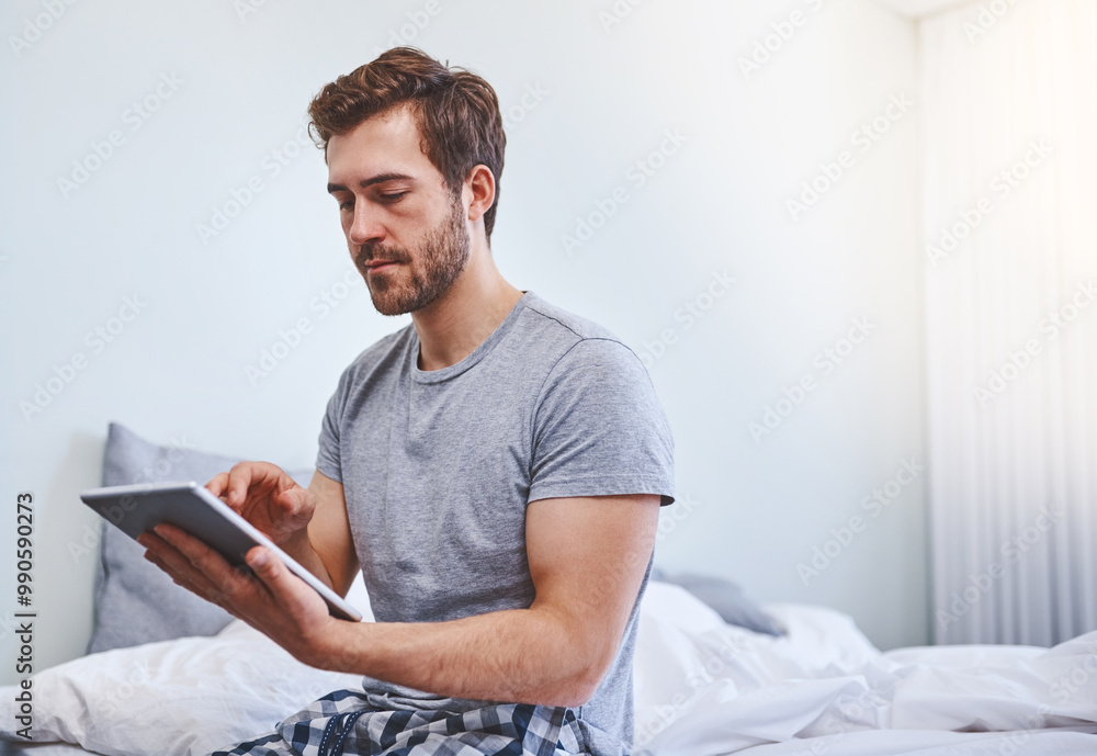 Man, tablet and scroll in bed in bedroom for morning news, social media and reading ebook in pajamas. Home, person and wake up with tech for online search, internet browsing or streaming subscription Man, tablet and scroll in bed in bedroom for morning news, social media and reading ebook in pajamas. Home, person and wake up with tech for online search, internet browsing or streaming subscription