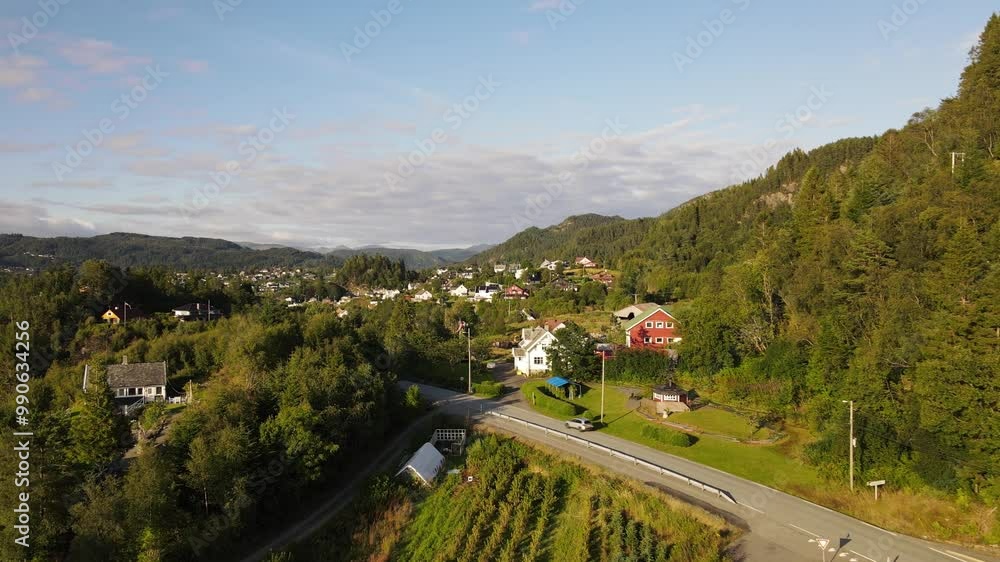 Aerial Drone Shot of Cars Driving Through Fana with Trees and Fanafjorden at Sunset, Bergen, Norway on a Sunny Day Aerial Drone Shot of Cars Driving Through Fana with Trees and Fanafjorden at Sunset, Bergen, Norway on a Sunny Day