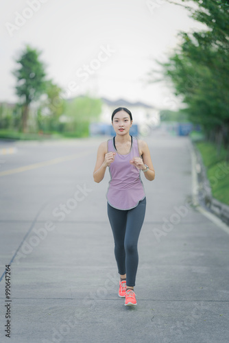 Asian girl exercising in the park. Fitness girl jogging for her own health.