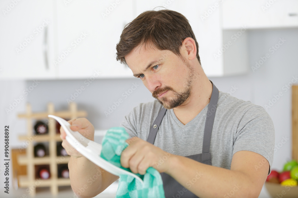 young man washing dishes