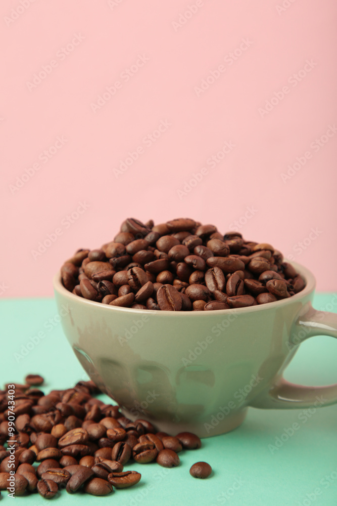 Fototapeta premium Coffee beans in coffee cup on colorful background. Vertical photo