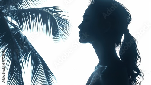 A captivating silhouette of a woman standing with her back to the ocean captures the essence of anticipation and wonder, beautifully framed by the beach