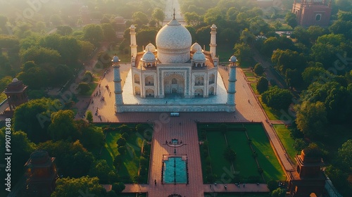 Aerial view of the majestic Taj Mahal enveloped by vibrant gardens, showcasing the elegance of this architectural wonder