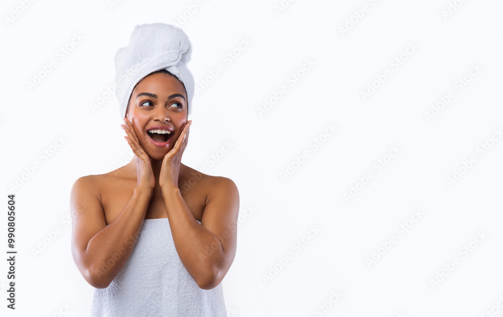 Shocked african woman in towels touching her cheeks and looking at free space, good offer at spa Shocked african woman in towels touching her cheeks and looking at free space, good offer at spa