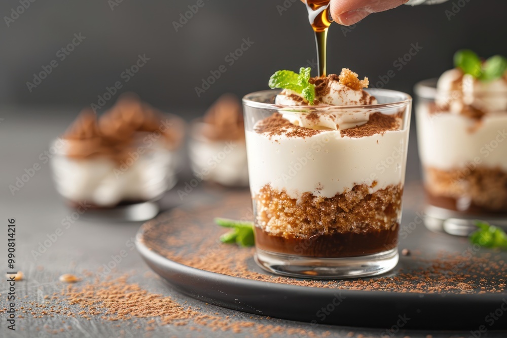 Person adding coffee extract to a dessert. Person adding coffee extract to a dessert.