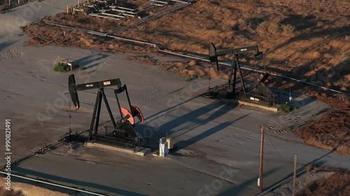 Aerial view of the oil rigs and wells in the Midway-Sunset shale oil fields, the largest in California. A pumpjack operates at an oil field. Oil pump rig energy industrial machine for petroleum.
