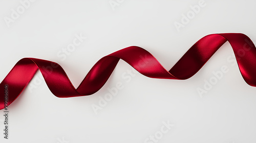 Red ribbon is curled up on a white background