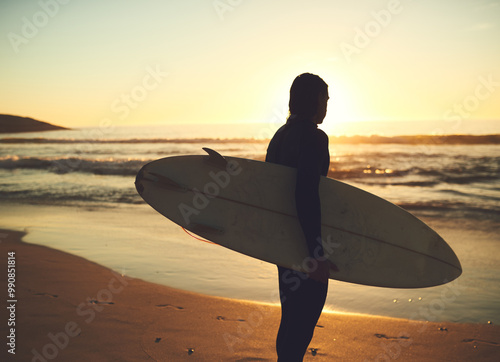 Travel, surfer and man with surfboard at beach for water sport, adventure or tropical vacation. Back, tourist and person for surfing at ocean with fitness, silhouette and activity for hobby or sunset